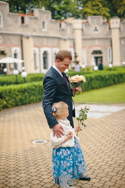 groom awaits with flower girl