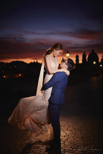 spinning his bride atop Charles Bridge