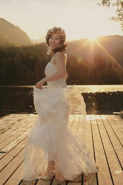 bride twirling her wedding dress Golden Light Lake Bled