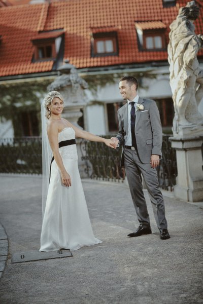 stylish newlyweds strolling through garden