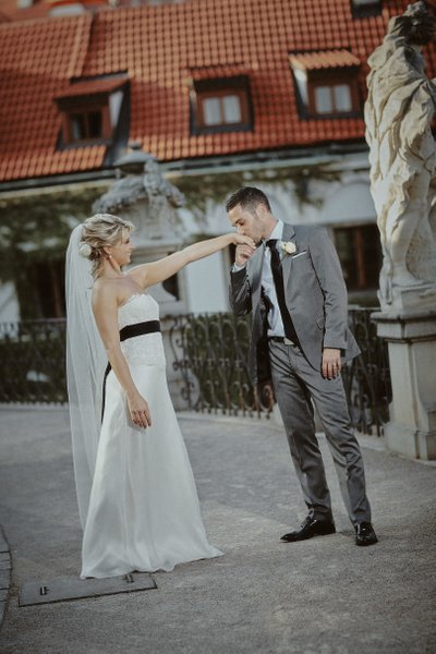 kissing his bride's hand