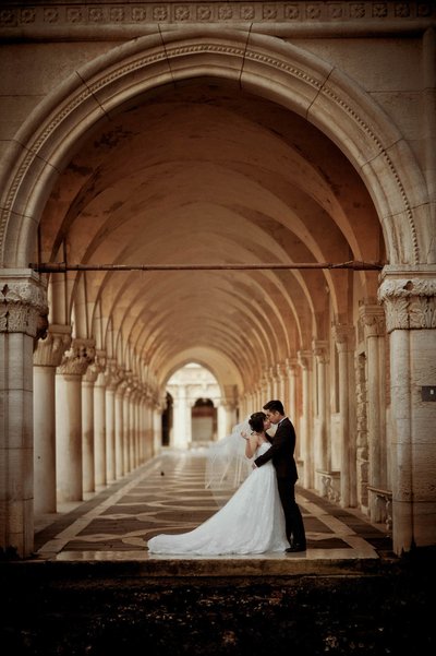 embracing under the portico of the Doge's Palace