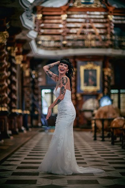 sexy tattooed bride laughing in Library