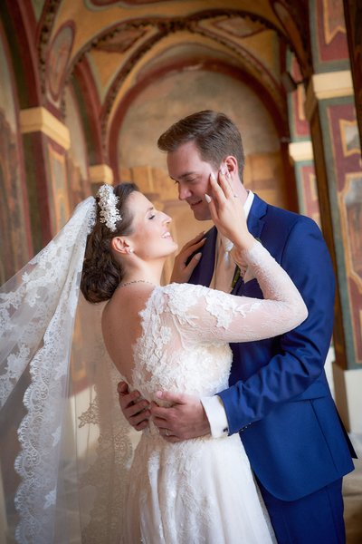 The bride caresses the groom's face Ledbour Garden Wedding