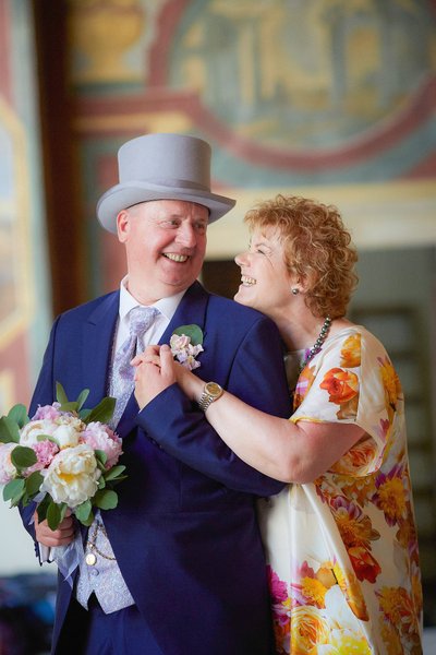 The Beaming Brides Parents Pose For A Wedding Portrait