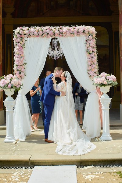 Newlyweds Kiss under Chandelier