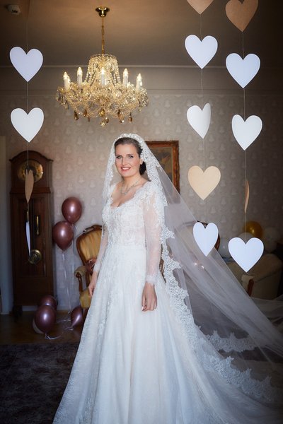 Paper hearts surround the bride on her wedding day in Prague