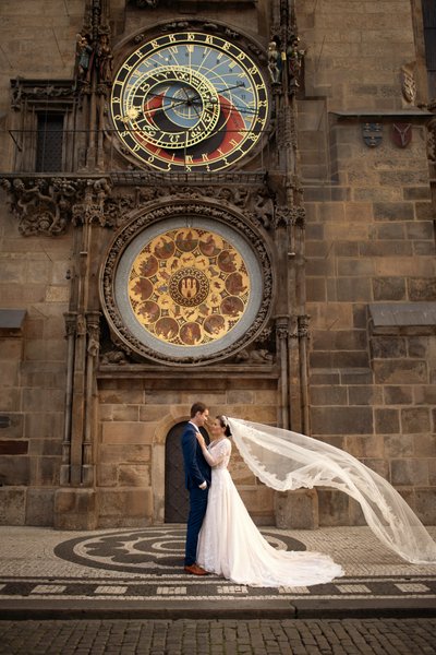 Newlyweds underneath the Astronomical Clock in Prague