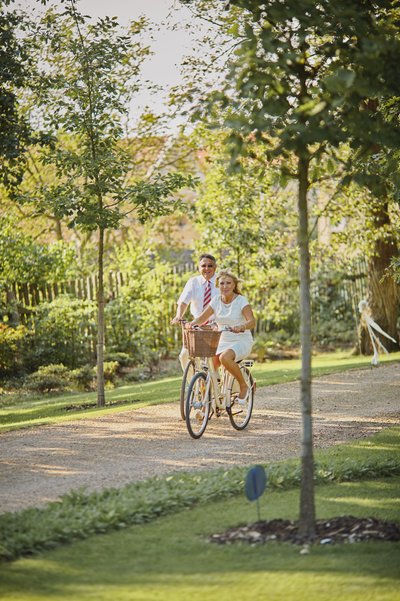 Groom's Parents tour the grounds on bikes