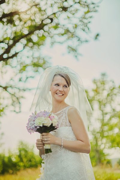 backlit bride holding bouquet