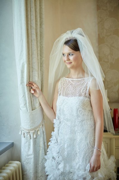 Bride looking out window