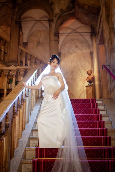 Bride sauntering down steps in Hotel Danieli