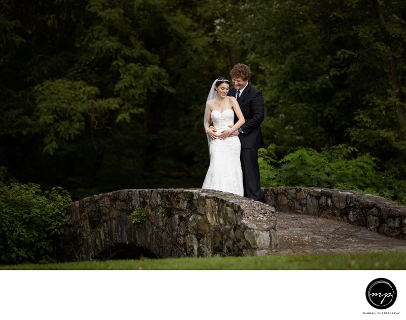 Bride and Groom on Stone Bridge in Forest