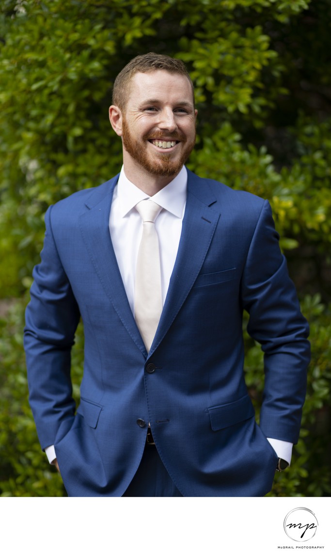 Groom in Blue Suit Smiling on Wedding Day