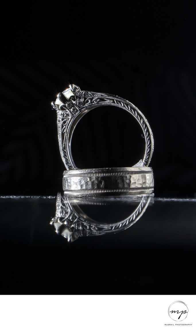 wedding photography details of rings with reflection