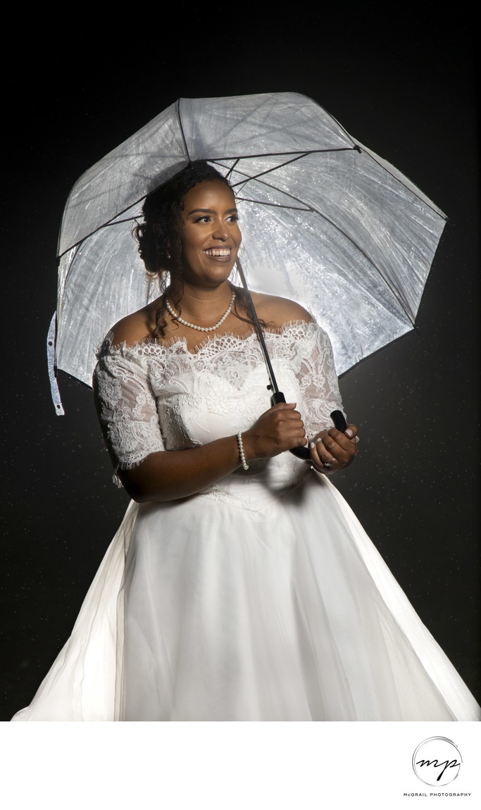 Radiant Bride with Umbrella on Rainy Wedding Day