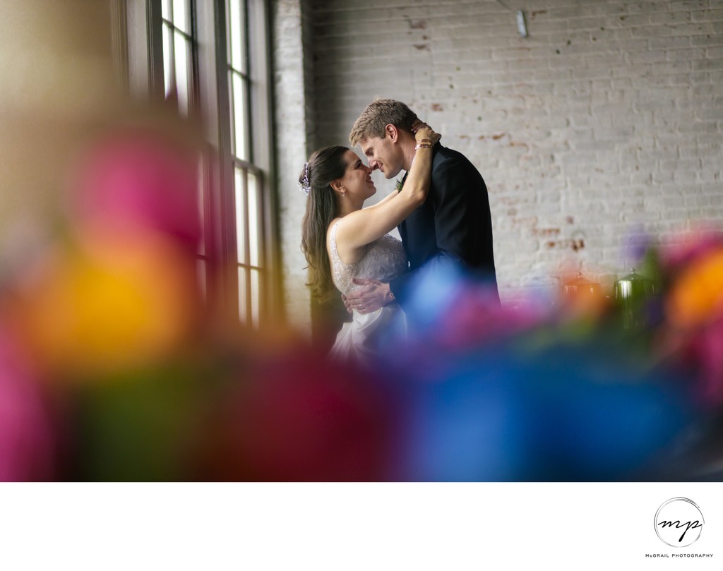 Romantic Embrace of Newlyweds in Industrial Venue