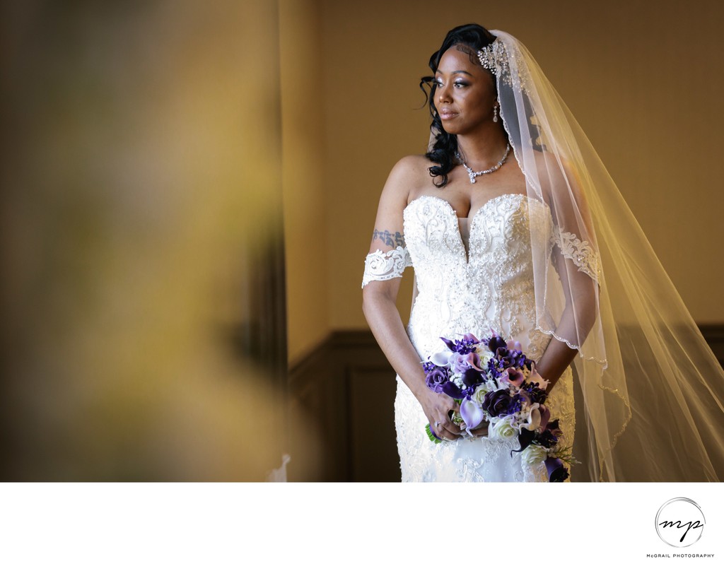  Bride with Veil Holding Bridal Bouquet In Window Light