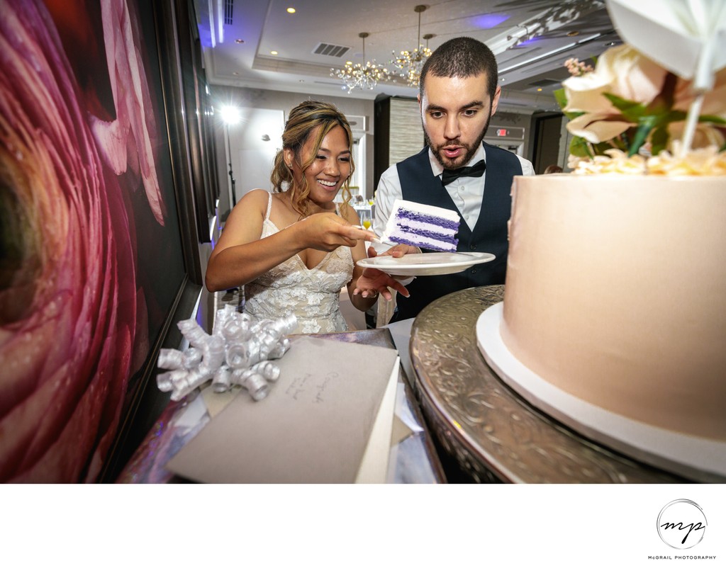 fun playful wedding photography of couple with cake