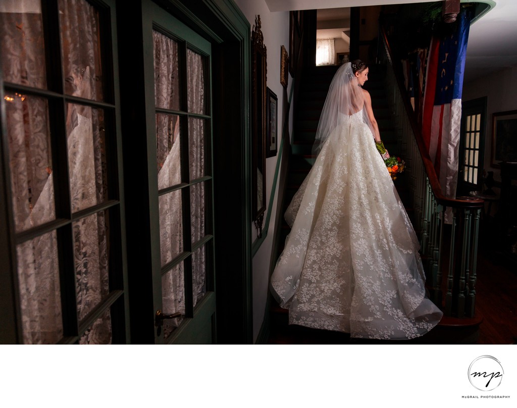 Elegant Bride Ascending Stairs in stunning lace ballgown