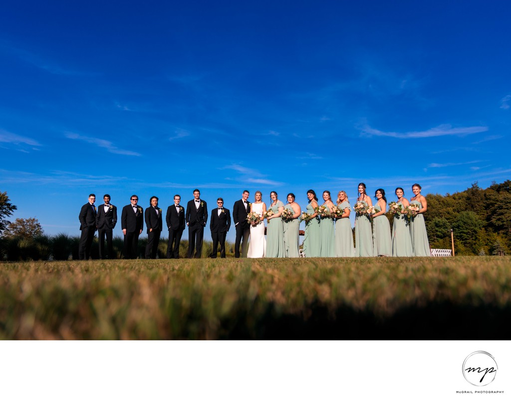 Bridal Party Posing Under  Blue Sky on Mountain top 