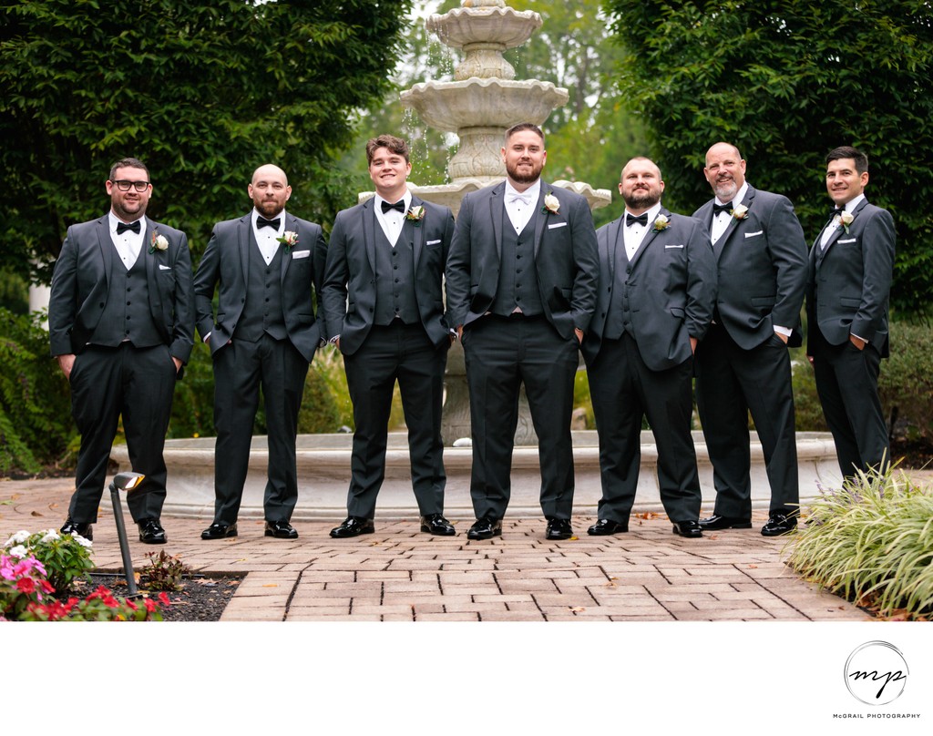 Groom and Groomsmen in Classic Tuxedos by Fountain