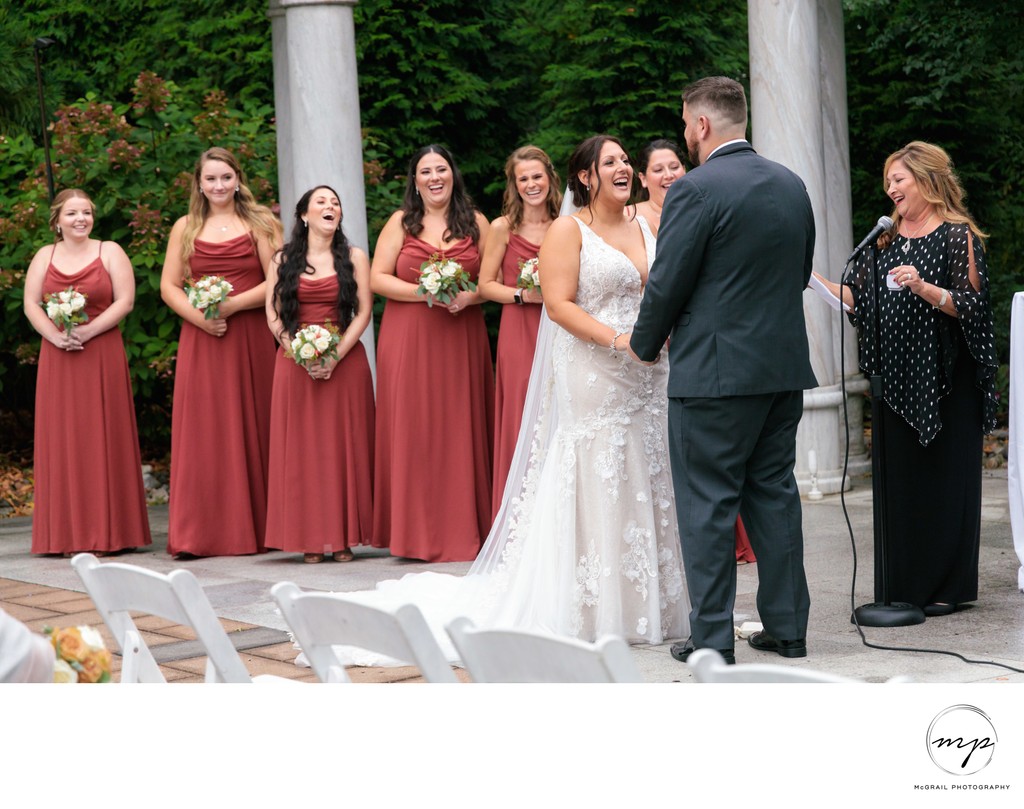 A Joyful Vow Exchange: Bride and Groom Sharing Laughter