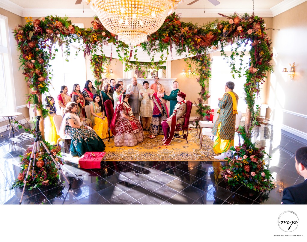 Traditional Indian Wedding Ceremony Under Floral Arch
