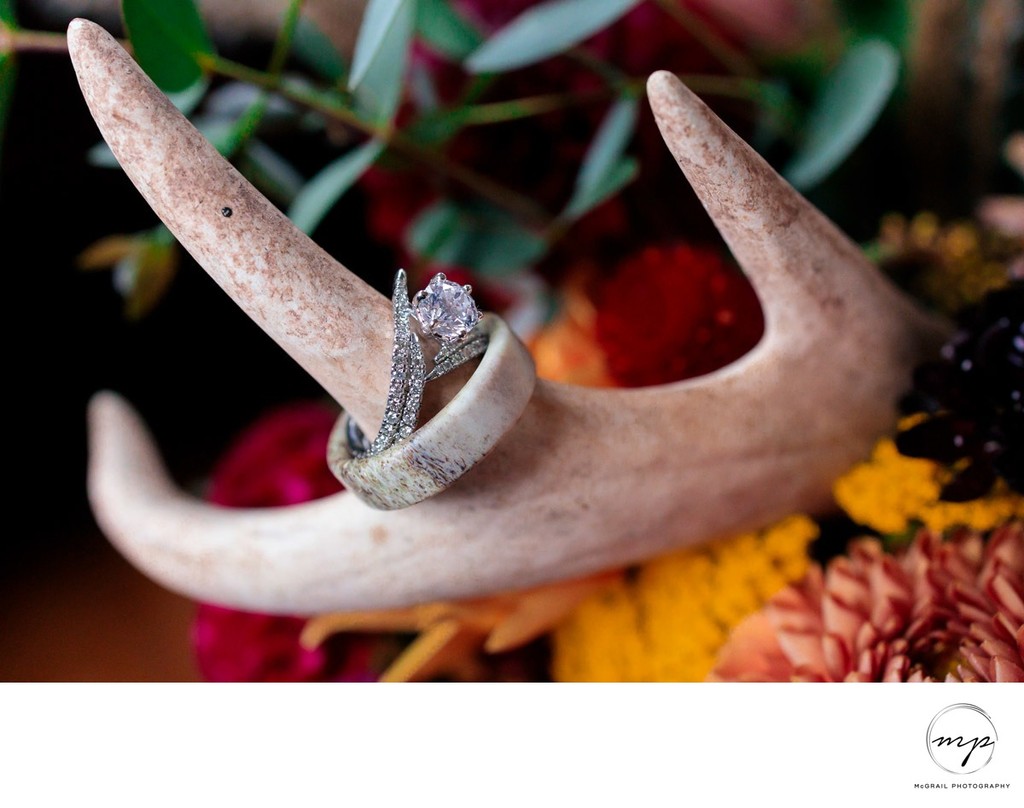 unique wedding details shot of rings on deer bones