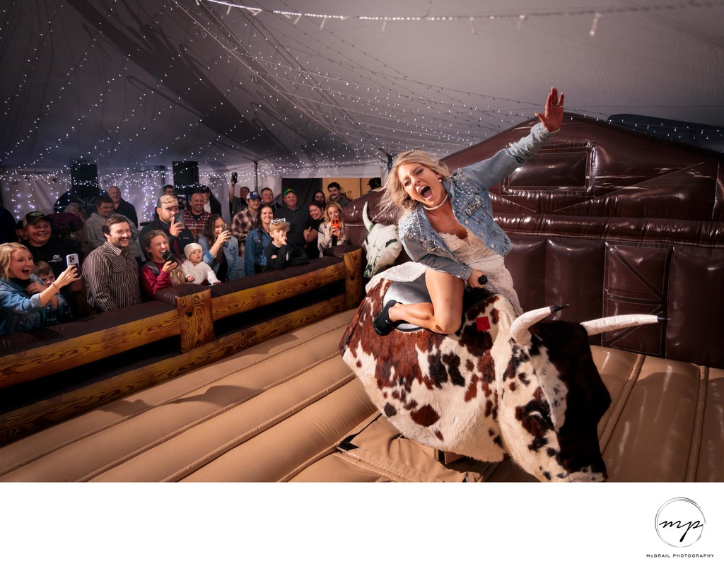 fun loving bull riding bride with excited crowd