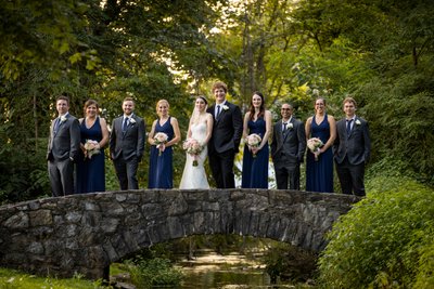 Bridal Party Posing on Stone Bridge at Cameron Estates