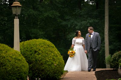 Bride and Groom Stroll Through Lush Garden