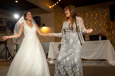 fun and lively  wedding photography of bride dancing