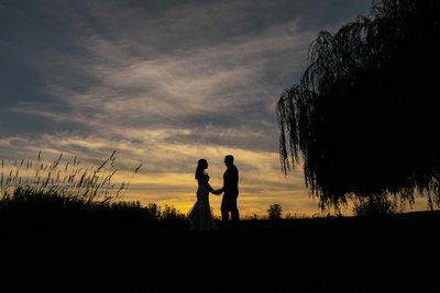 silhouette wedding photography of couple at sunset