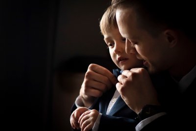 dramatic and uniquely lit portrait of ring bearer 