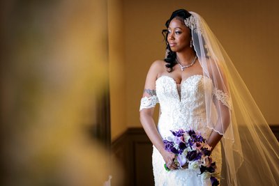  Bride with Veil Holding Bridal Bouquet In Window Light