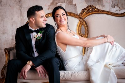classic elegant portrait of bride and groom on a couch