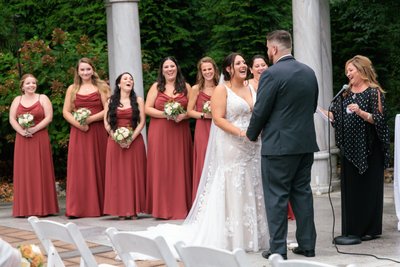 A Joyful Vow Exchange: Bride and Groom Sharing Laughter