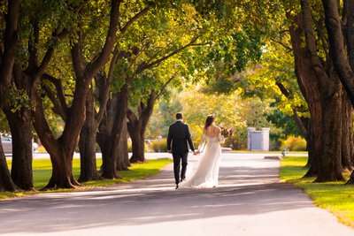 The Bride and Groom's Romantic Walk Down Tree Lined St. 