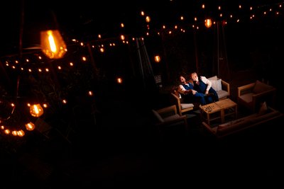 Two Grooms Share a Romantic Evening Under String Lights