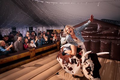 fun loving bull riding bride with excited crowd
