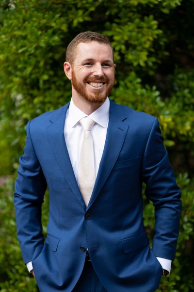 Groom in Blue Suit Smiling on Wedding Day