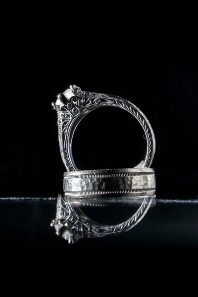 wedding photography details of rings with reflection