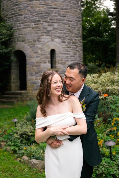 Joyful Couple Embracing by Stone Tower