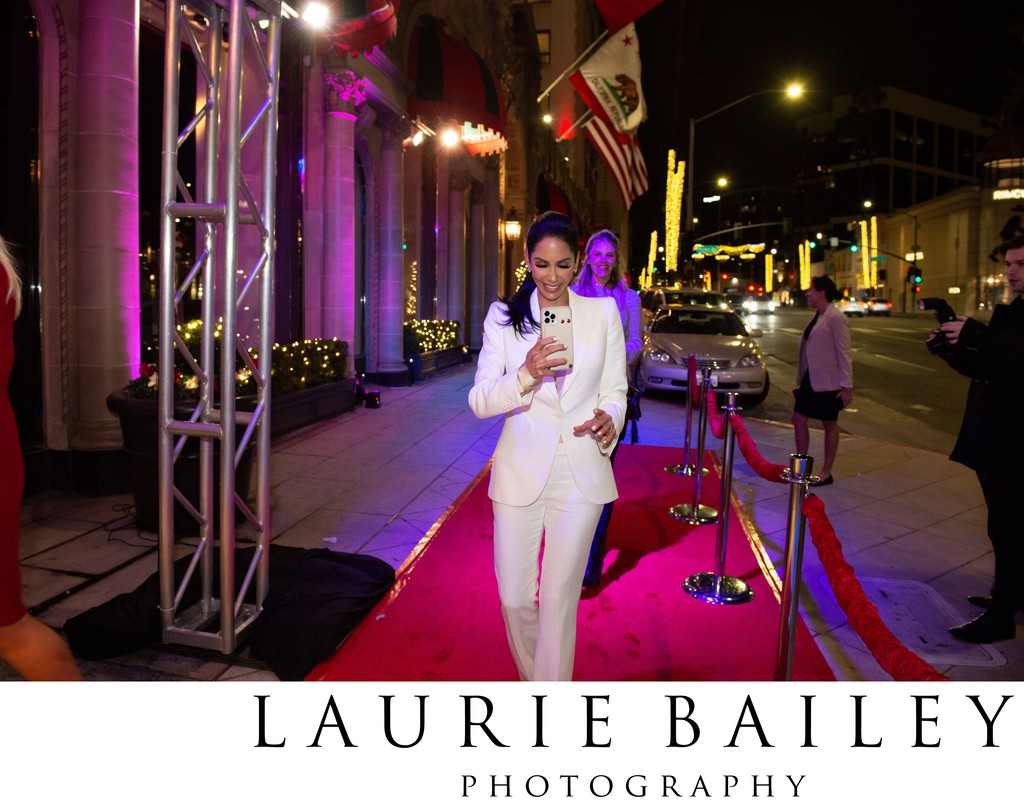A guest walks the Beverly Wilshire red carpet under LA glow