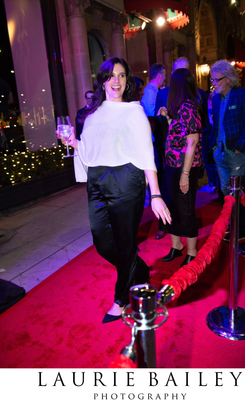 A guest pauses for a red carpet portrait at Beverly Wilshire