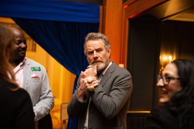 Bryan Cranston mugs for the camera, showing off his rings