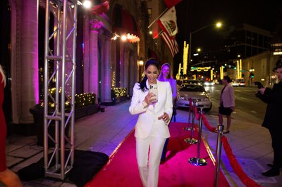 A guest walks the Beverly Wilshire red carpet under LA glow