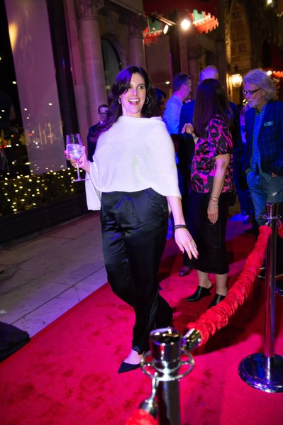 A guest pauses for a red carpet portrait at Beverly Wilshire