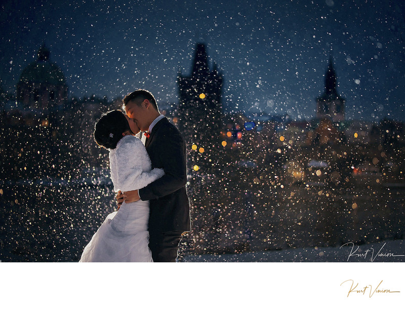 winter kiss in snow Prague weddings Charles Bridge